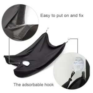 Black beard apron with hook-and-loop neck closure and suction-cup hanging attachment, close-up