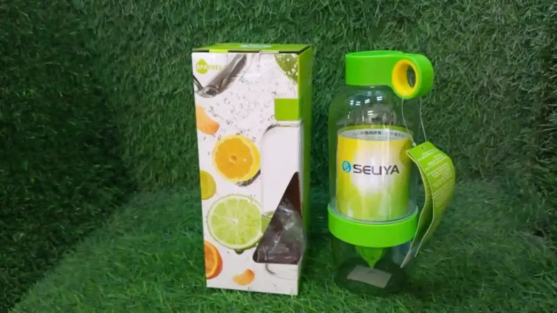 Bottle and retail packaging box shown together on a grass background