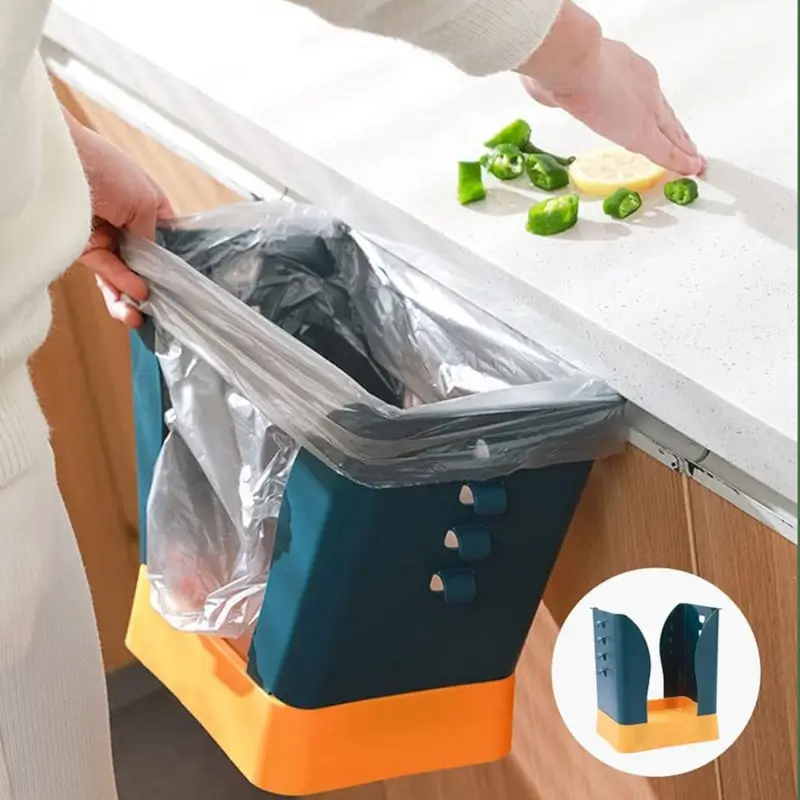Hand holding a garbage bag open inside the frame while propped against a kitchen counter