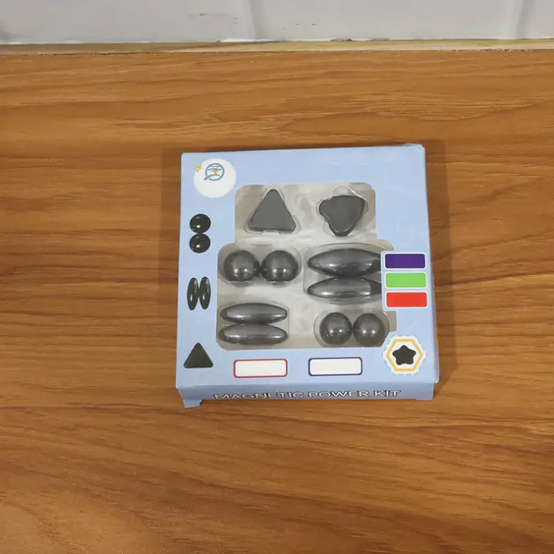 Magnetic Power Kit packaging shown open, with triangle, teardrop, sphere and oval magnetic pieces in their tray
